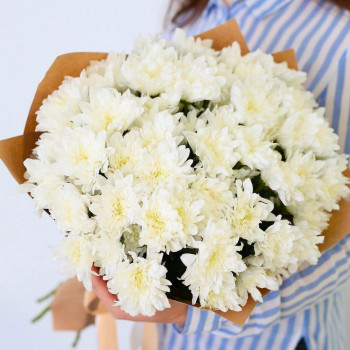 White chrysanthemums wrapped in kraft paper